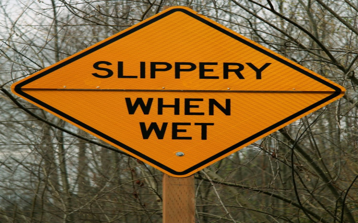 caution slippery road sign